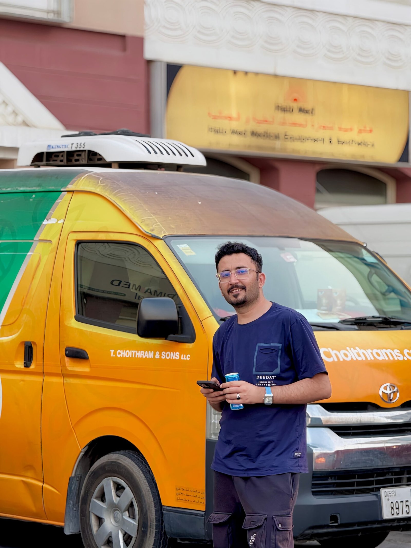 Man standing in front of a refrigerated chiller van in Dubai used for temperature-controlled delivery services